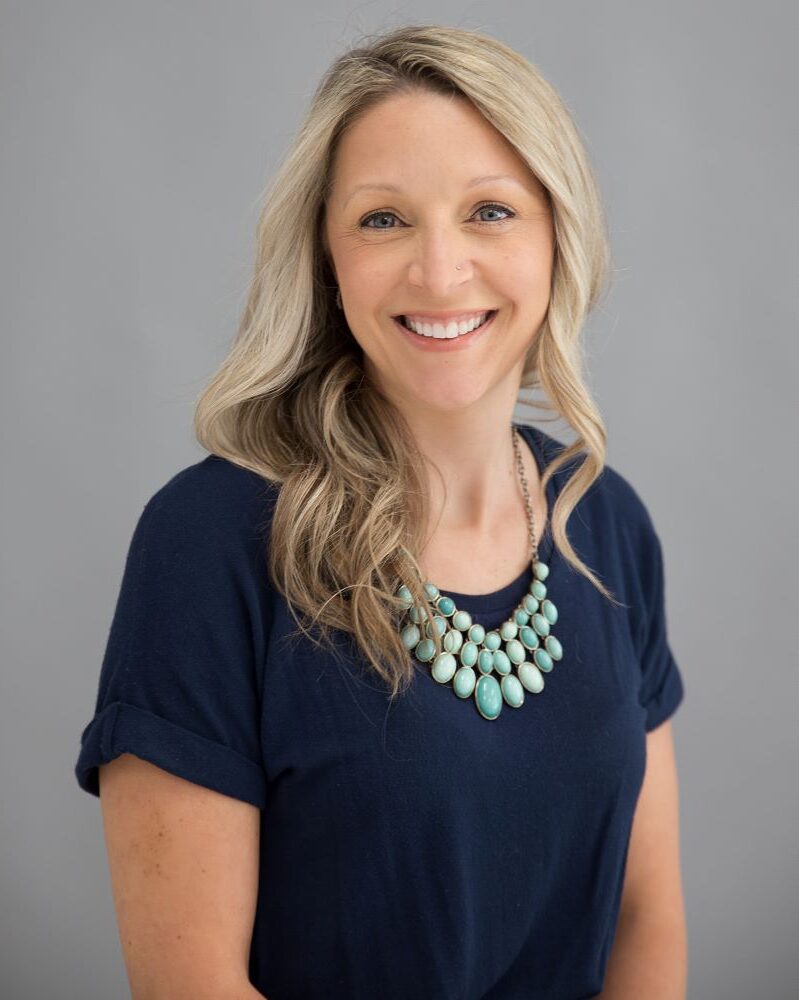 Smiling woman with long blonde hair.