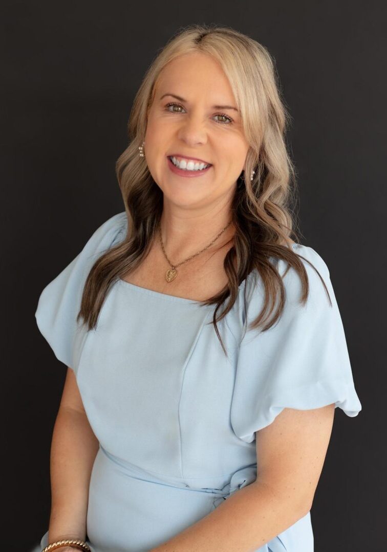 Portrait of a smiling woman in pale blue