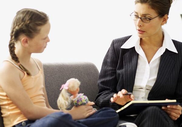 Child and woman sitting, having a conversation.